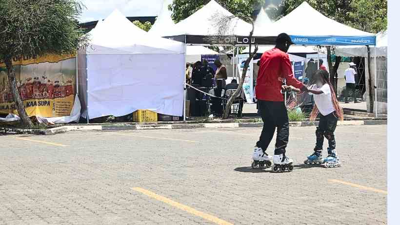 Skate trainer teaching a child how to skateboard in Nairobi