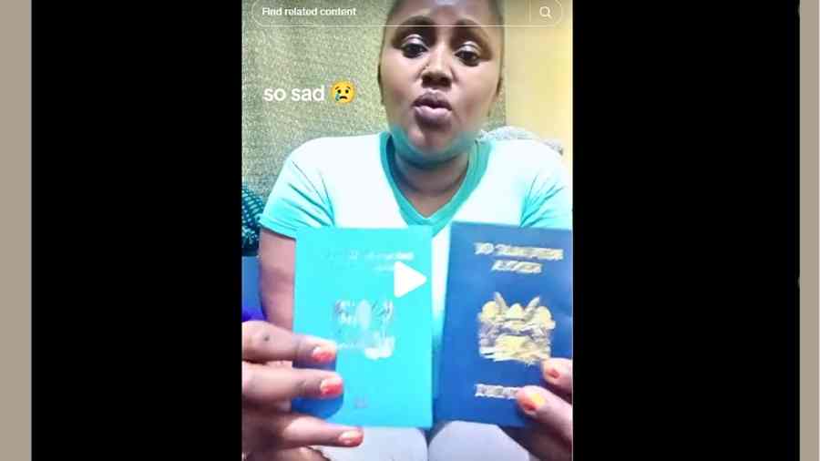 Kenyan TikToker Imma Marika seated while displaying her unused biometric passport during a TikTok video.