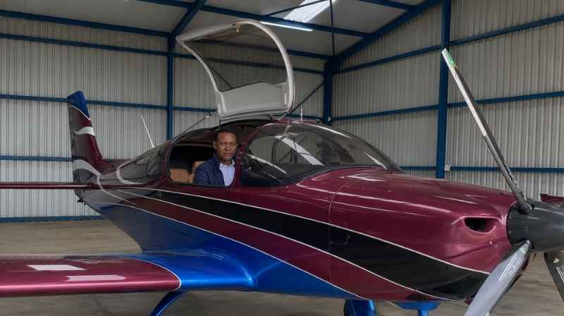 Image Title: Alfred Mutua in Aircraft Cockpit Alt Text: Alfred Mutua seated in the cockpit of a light aircraft