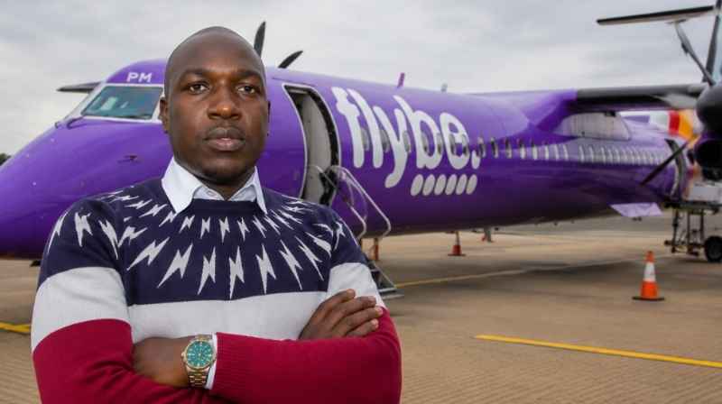 Barrack Siglain With Dash 8 Q400 Aircraft Pilot Barrack Siglain standing in front of a Dash 8 Q400 aircraft